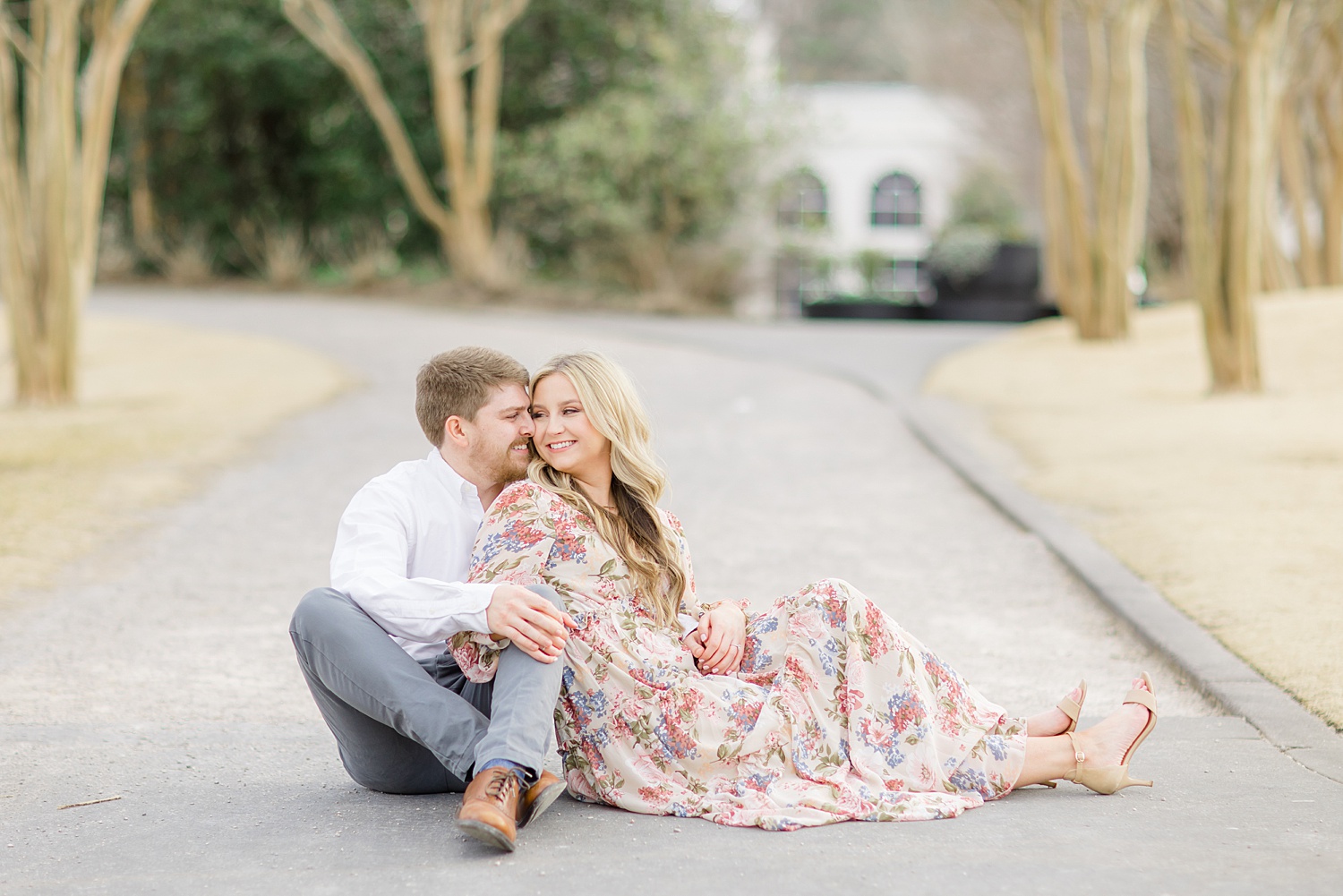 couple sits in road during 2022 Birmingham Engagement session