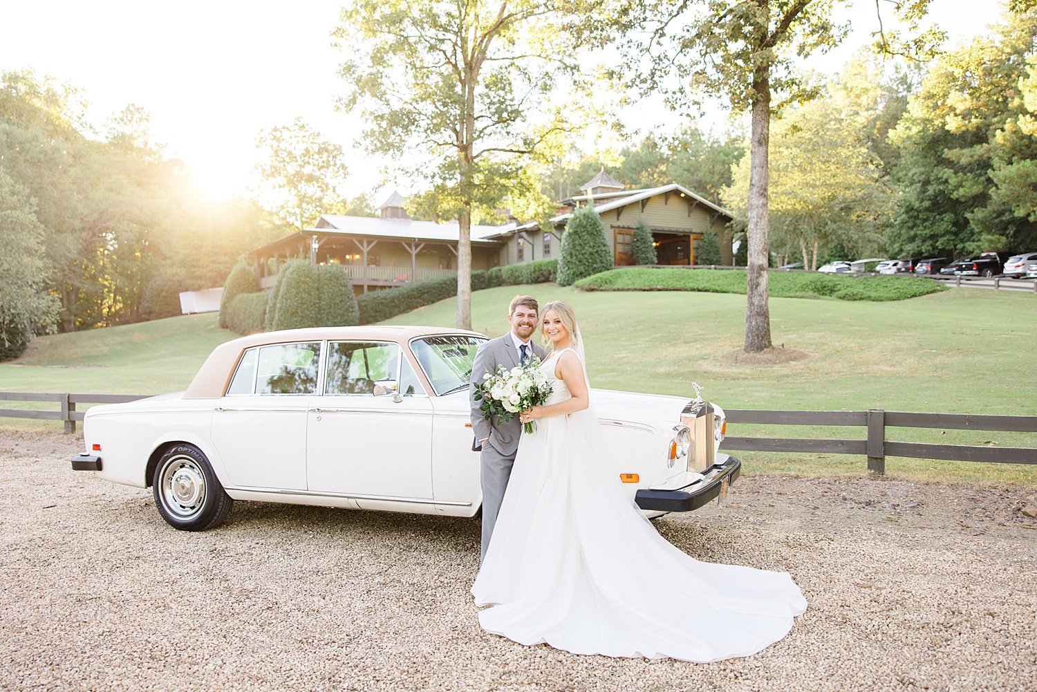 newlyweds stand in front of classic car