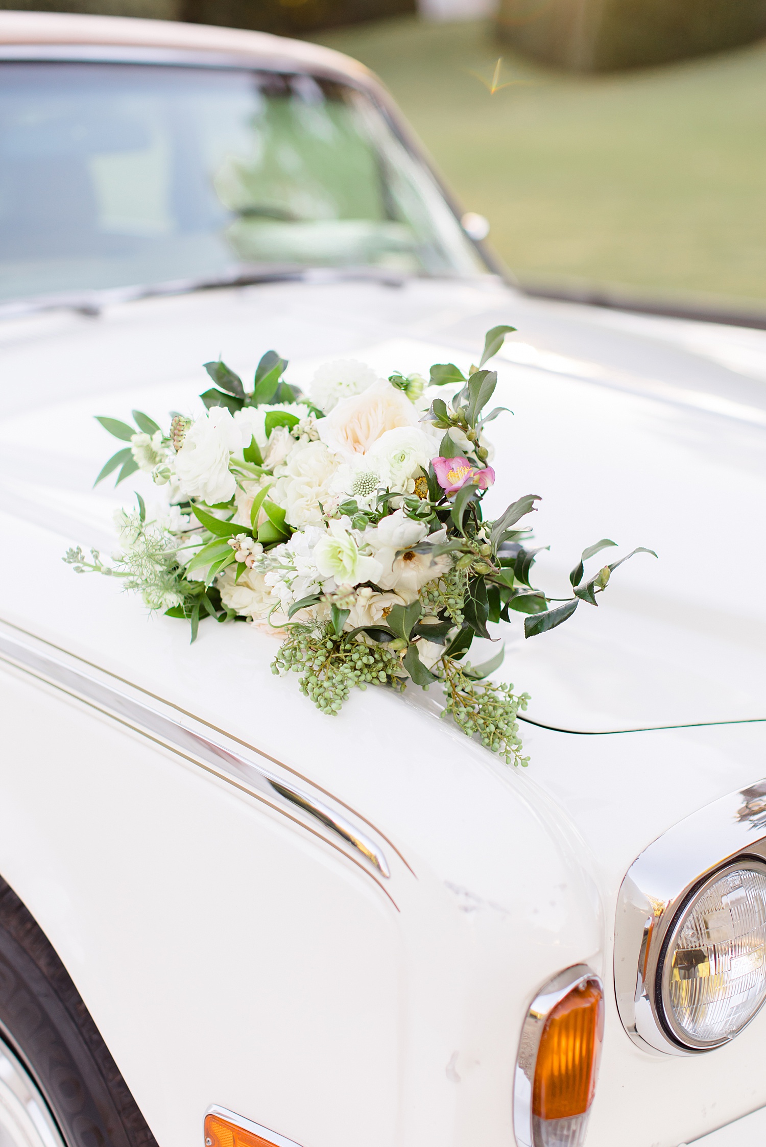 wedding bouquet on car