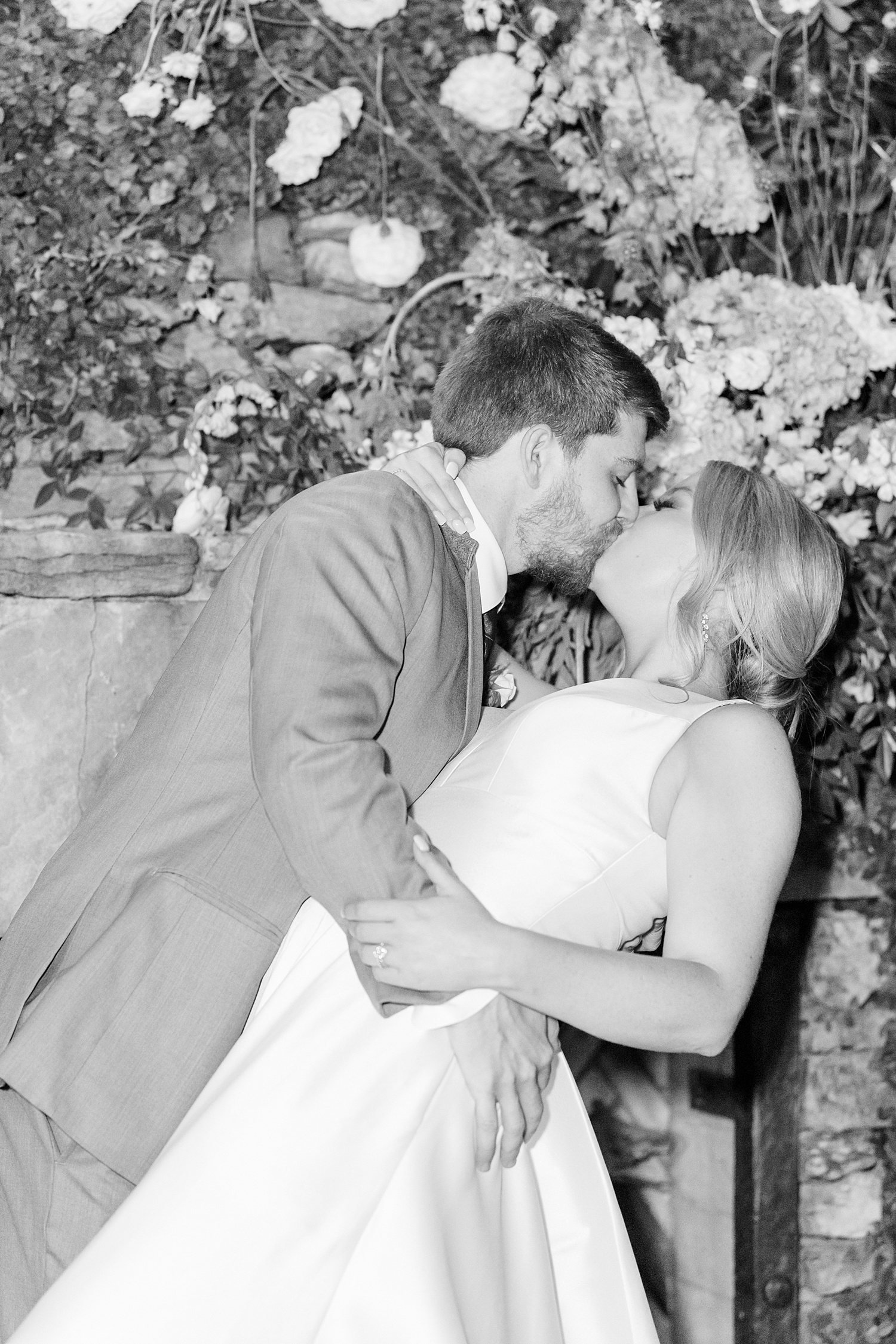newlyweds kiss at Elegant Windwood Equestrian Wedding reception