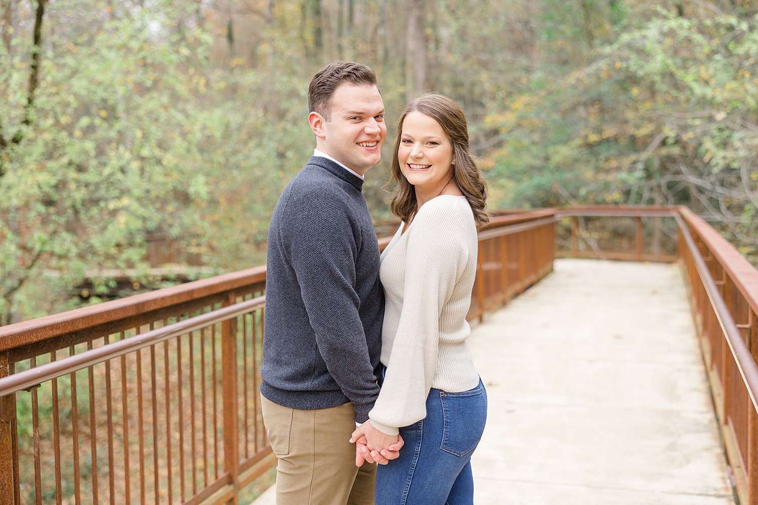 couple on wood bridge at Jemison Trail in Mountain Brook, Alabama
