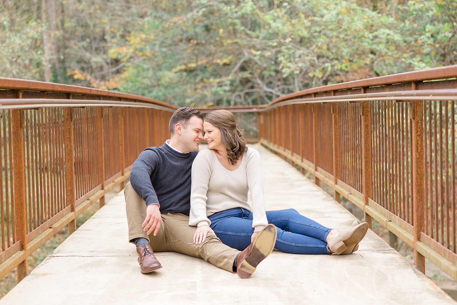 couple sit on bridge