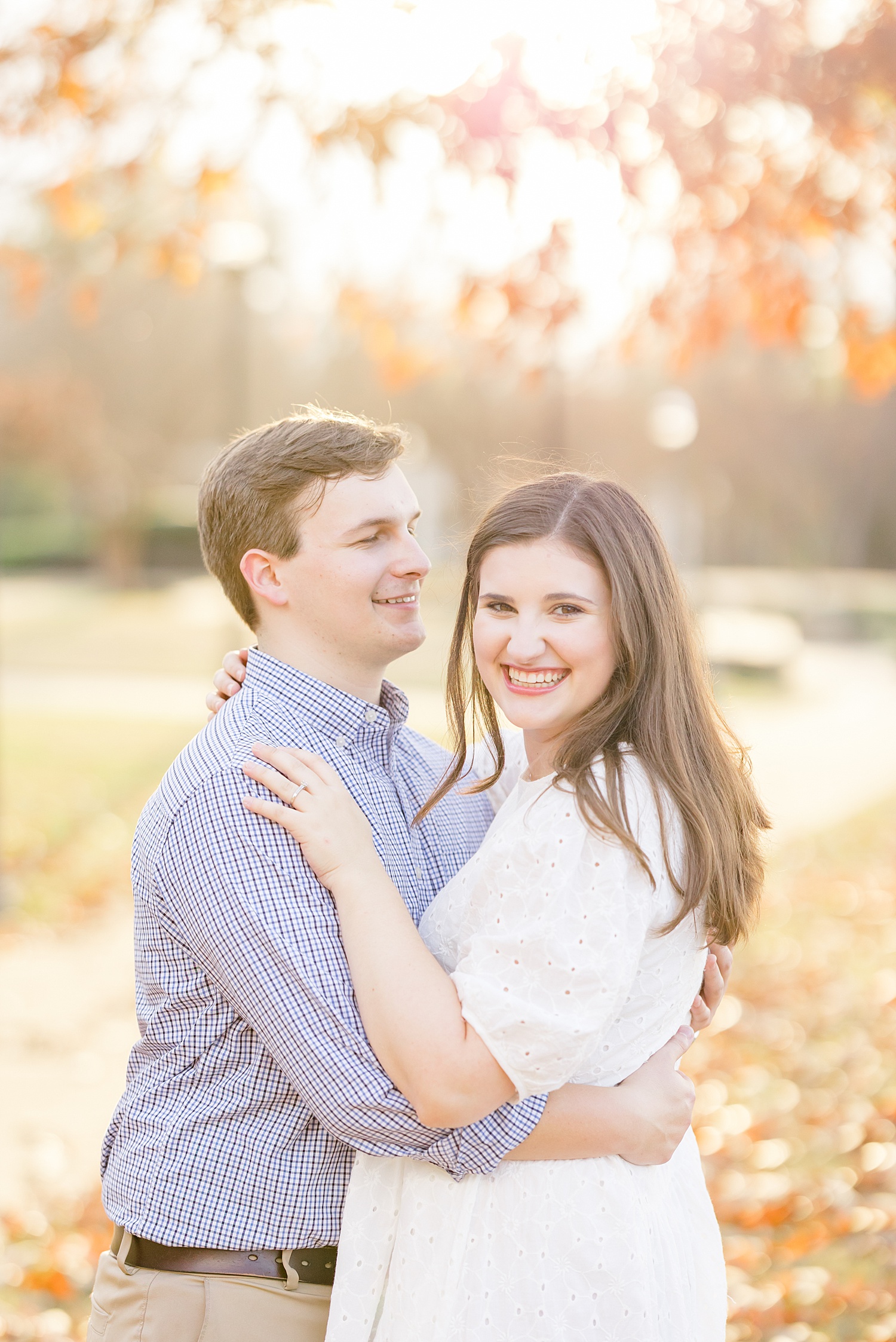 couple under tree during fall engagement 