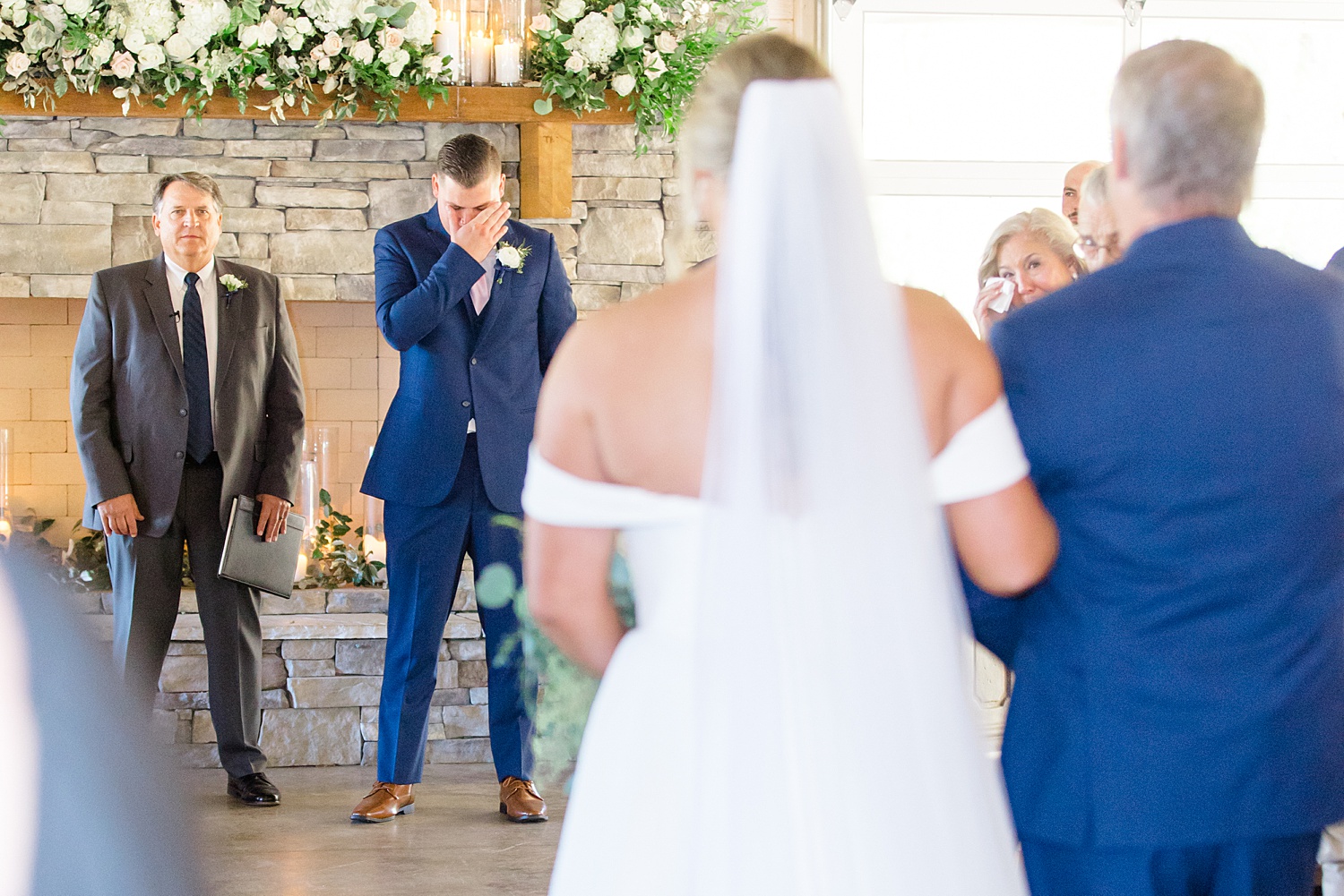 emotional groom seeing bride walk down the aisle