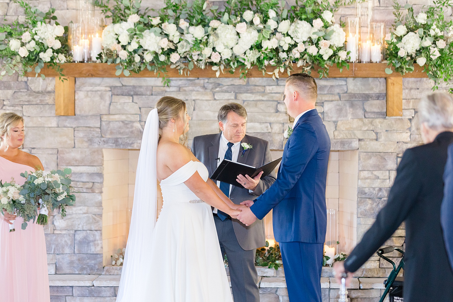 couple exchange vows during indoor wedding ceremony at Mathews Manor
