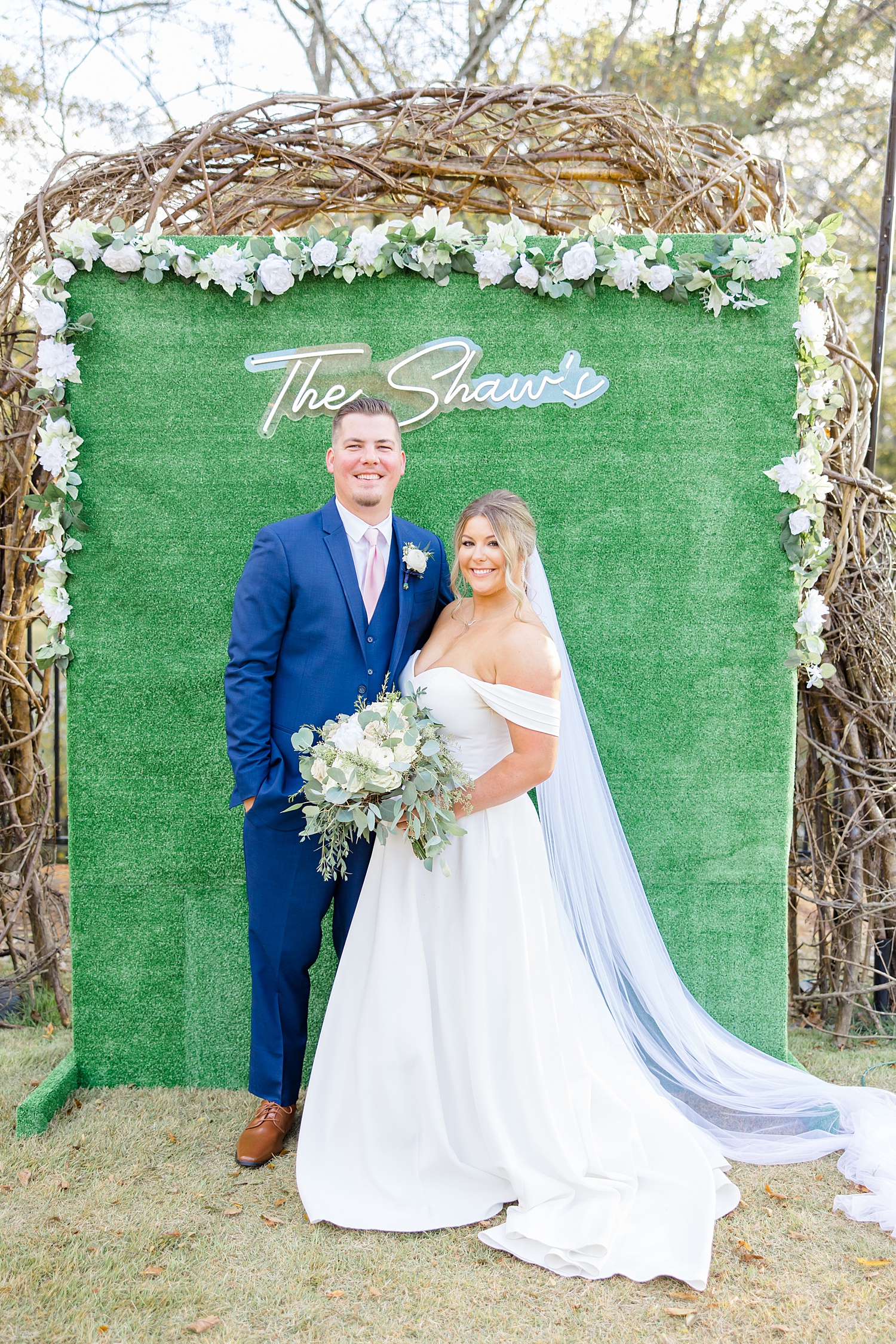 newlyweds in front of wedding sign 