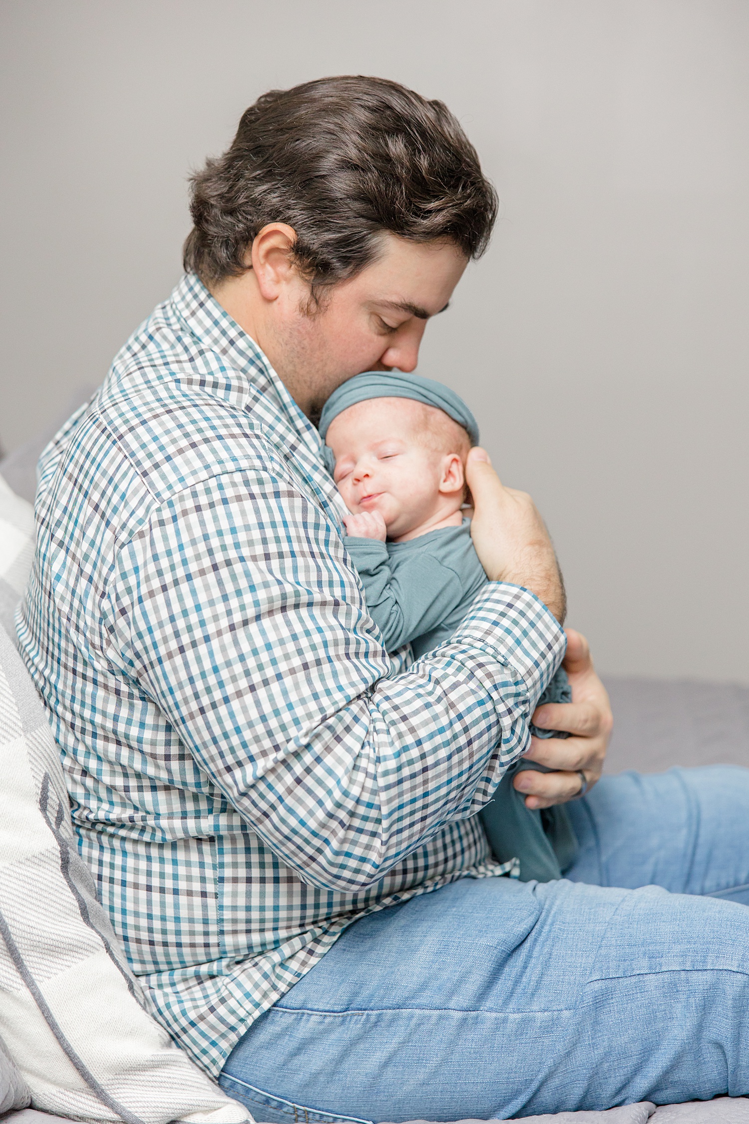 candid photo of dad holding newborn girl
