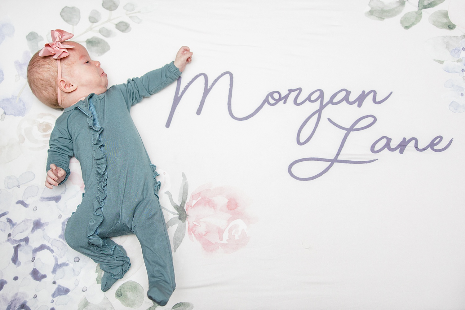 newborn girl next to blanket with her name during Birmingham Newborn and Lifestyle Session