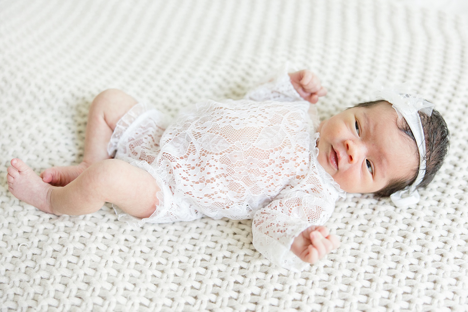 In-Home Newborn portraits of baby girl in white lace outfit 