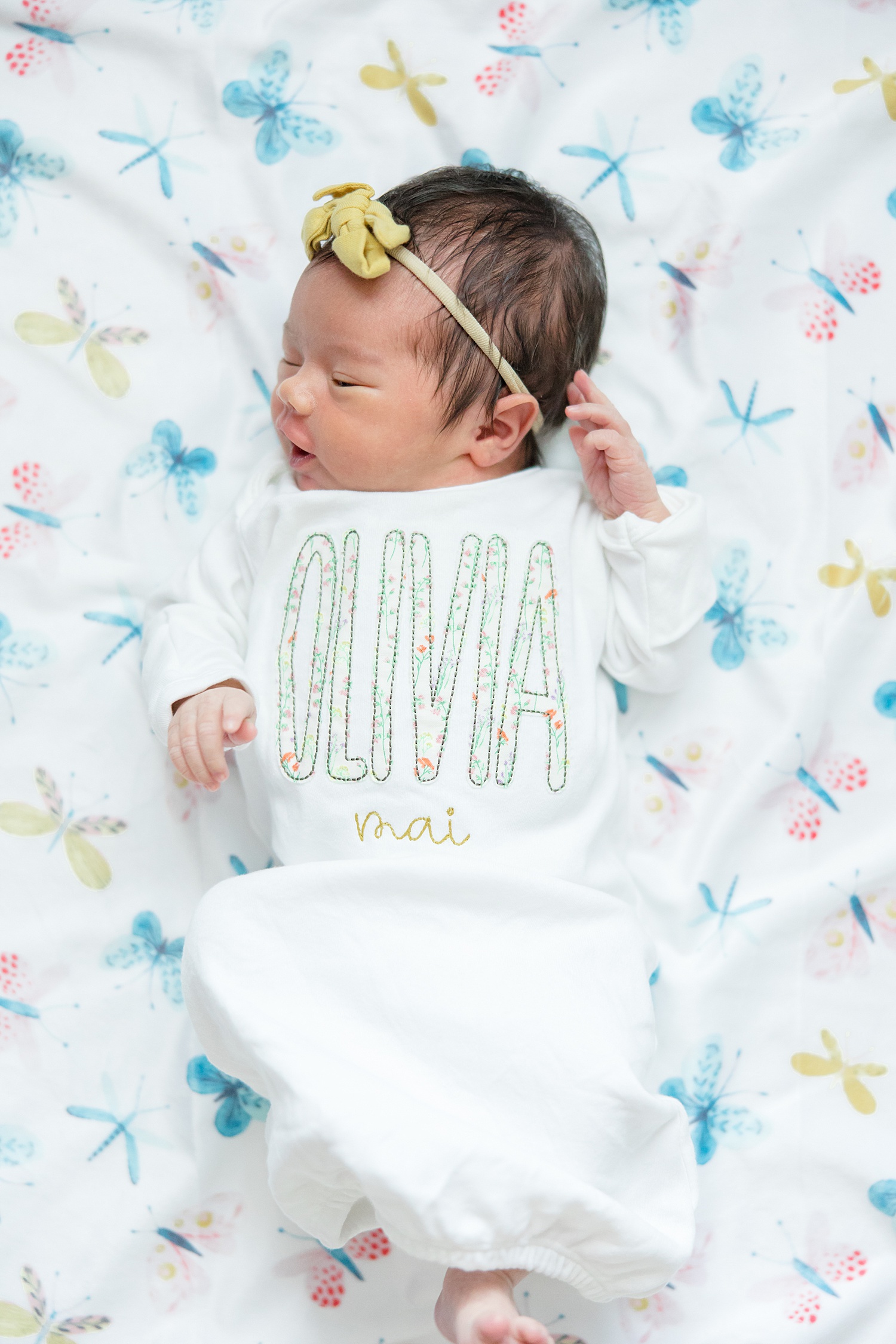 newborn girl in personalized onesie 