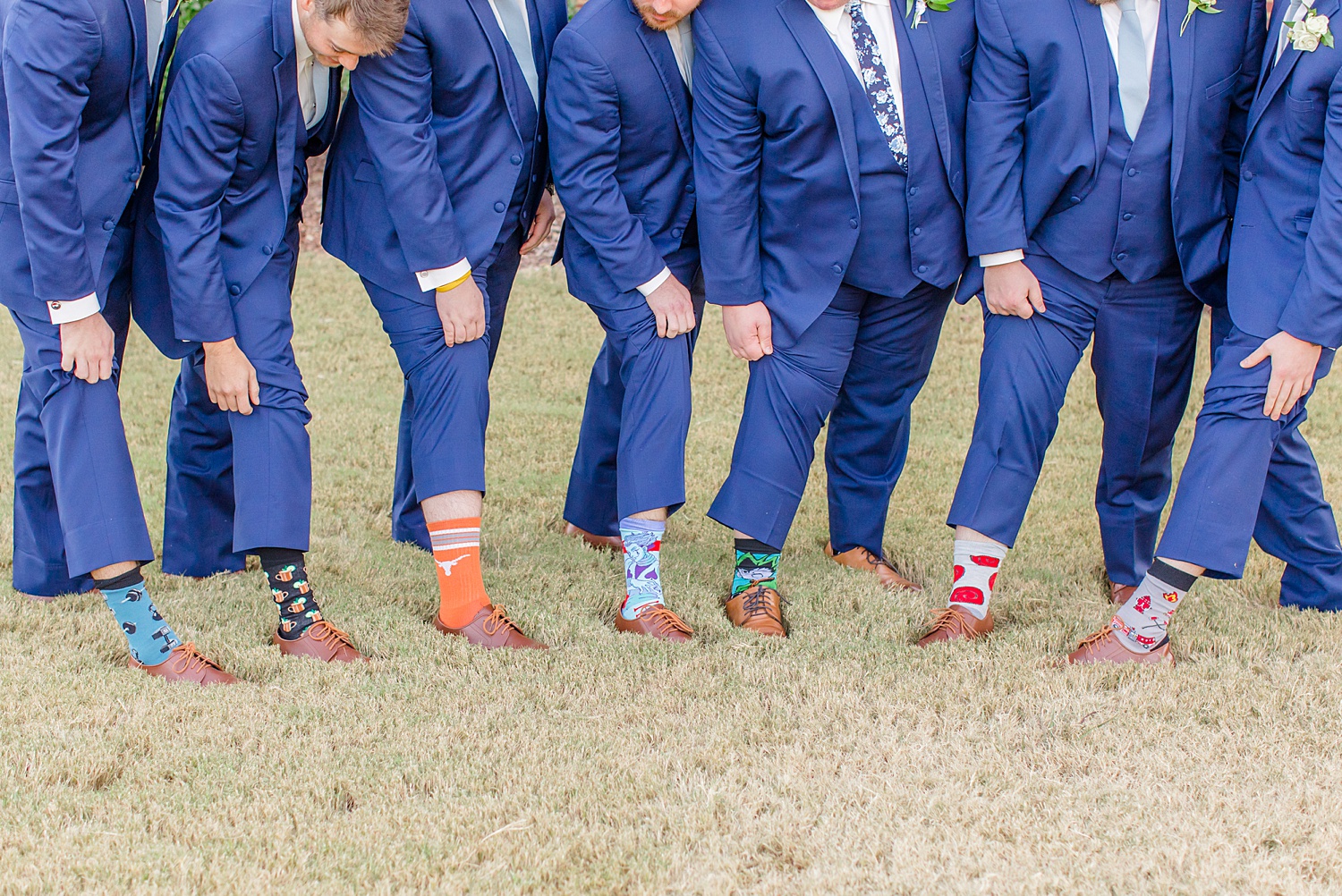 groomsmen and groom show off socks 