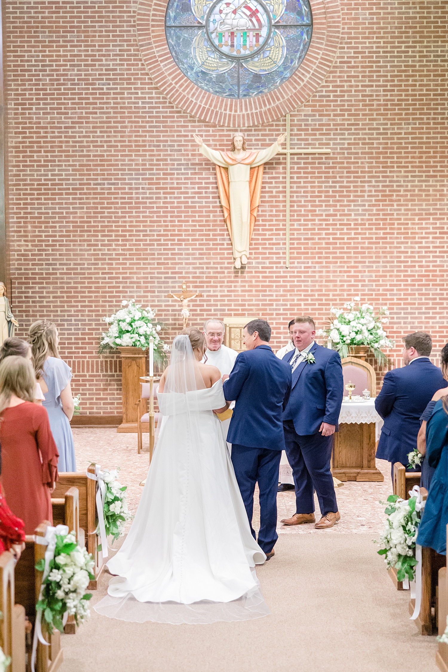 father of the bride hands off bride to groom