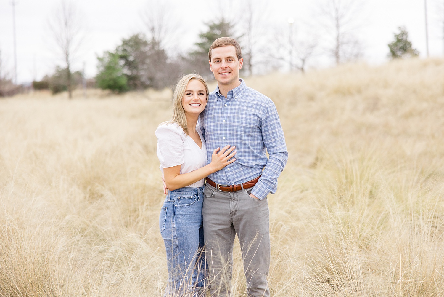 couple stand in field of tall grass