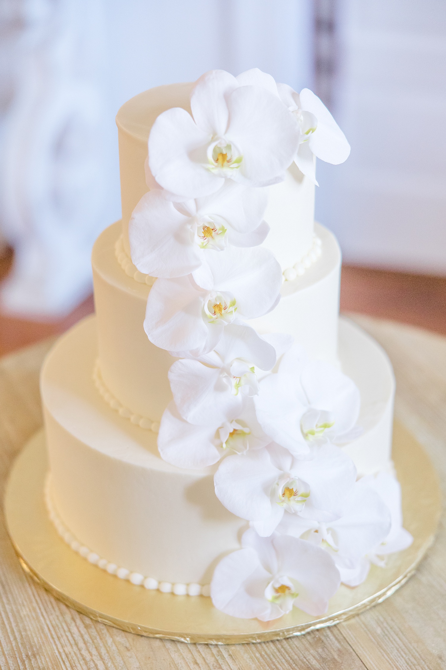 classic white four tiered wedding cake with white flowers