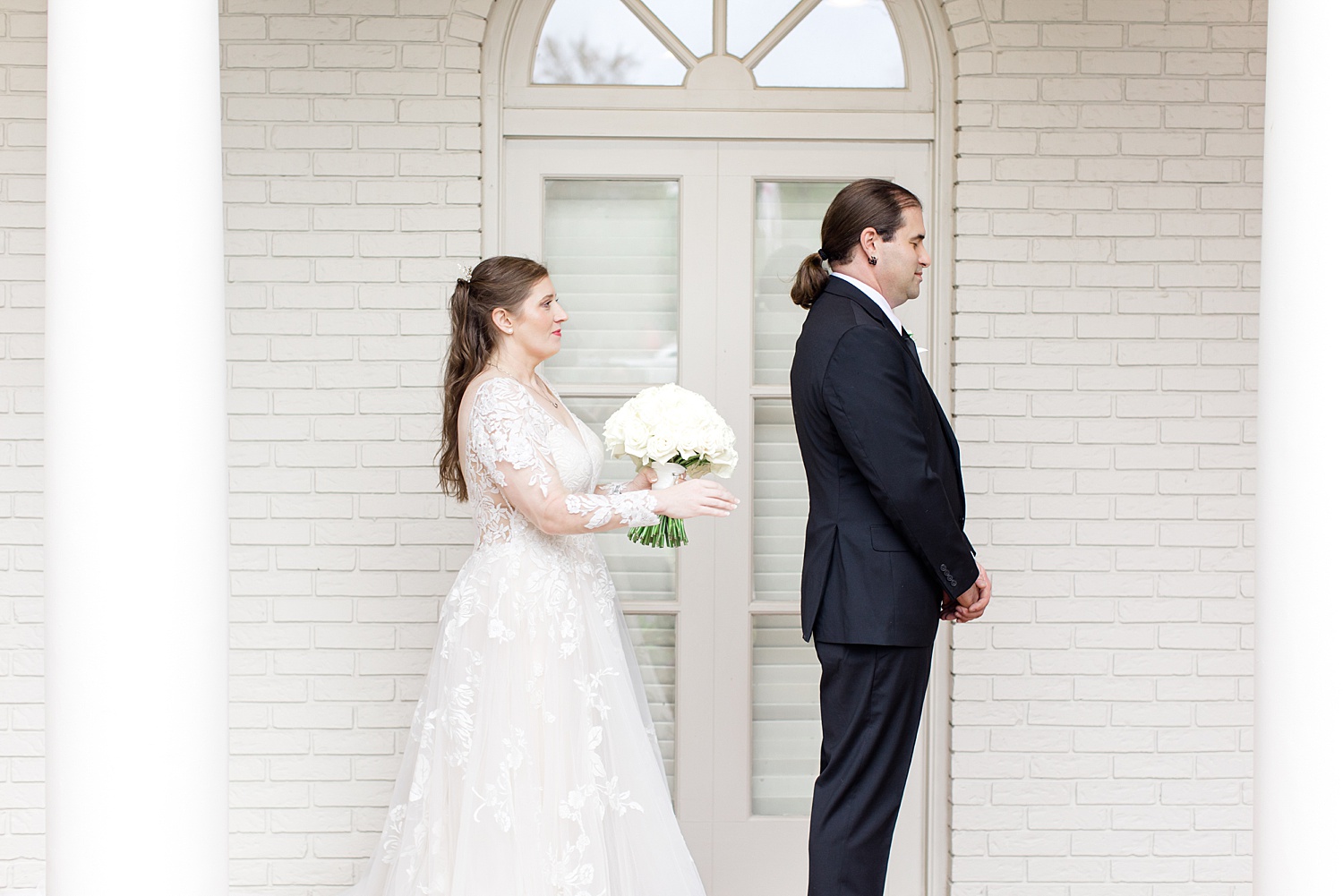 bride walks behind groom for first look 
