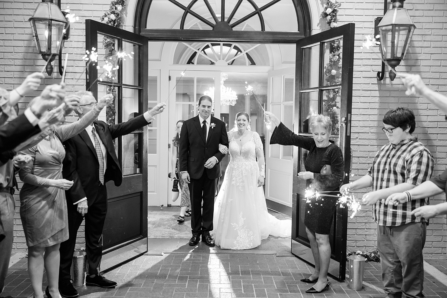 wedding guests send off newlyweds with sparkler exit