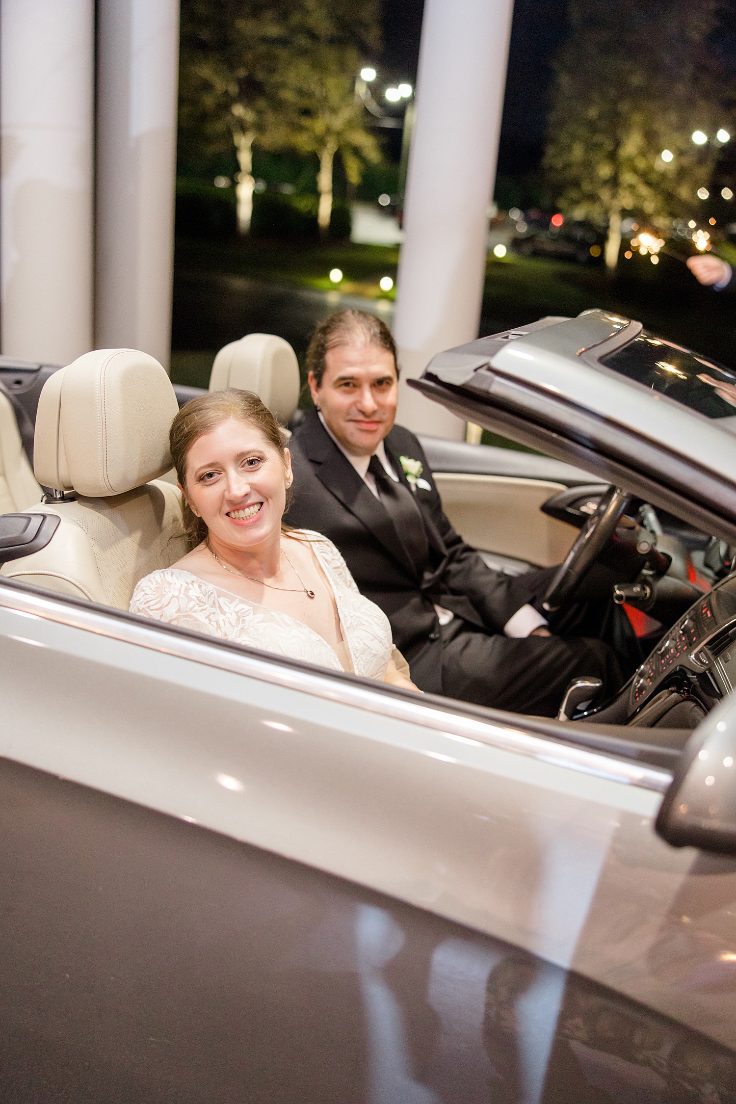 bride and groom in getaway car