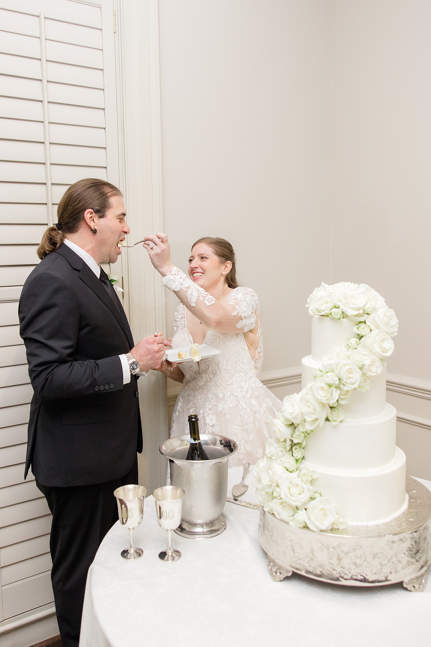 bride feeds groom wedding cake