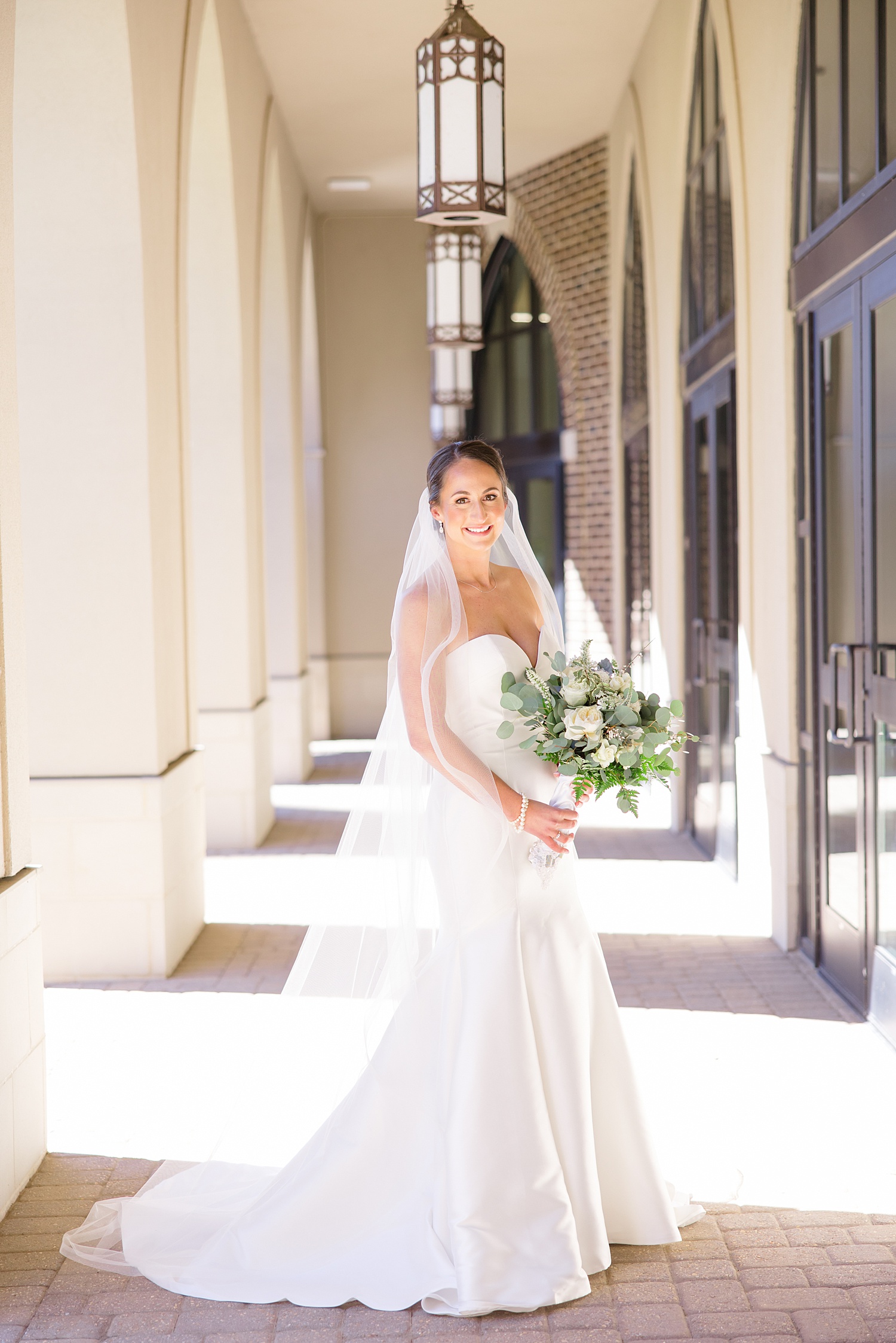 bridal portraits under beautiful outdoor archway 