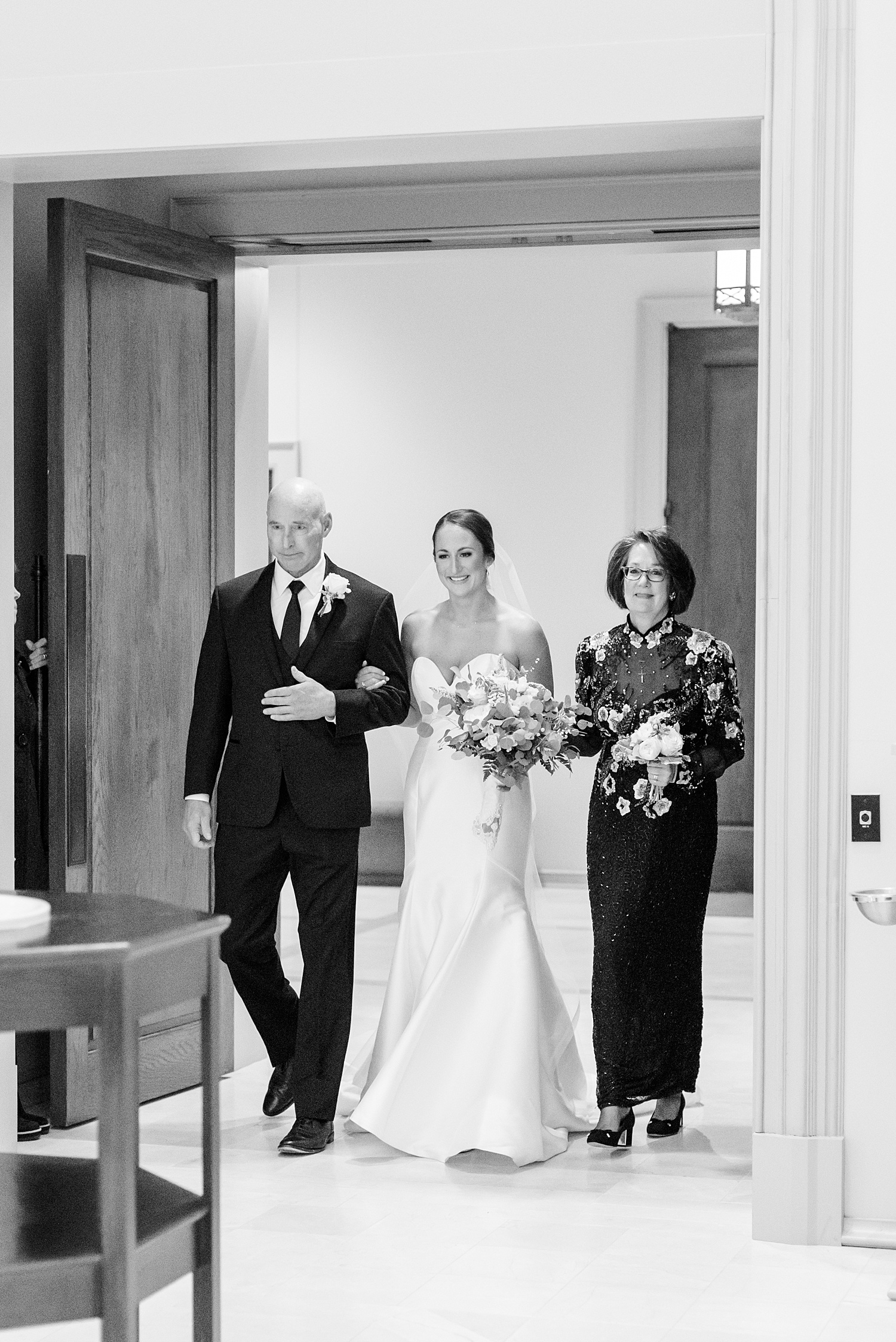 bride walks down aisle with her parents