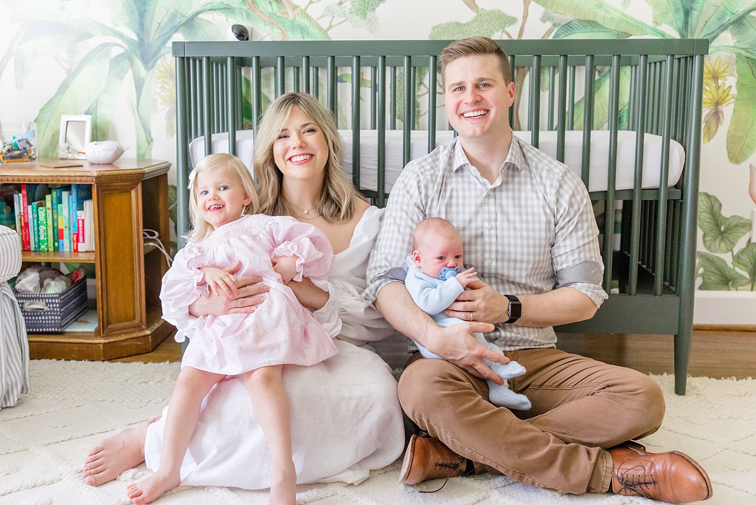 family of four sit on floor of nursery during Mountain Brook Alabama At-Home Newborn Session