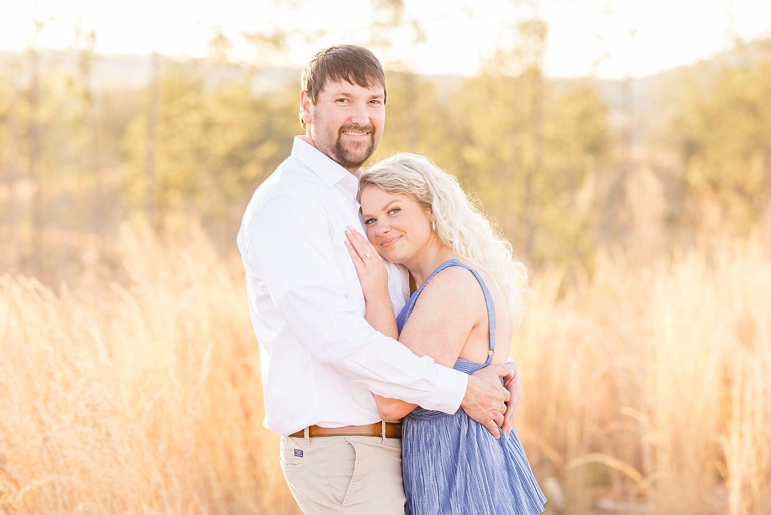 woman leans into man during their engagement portraits 