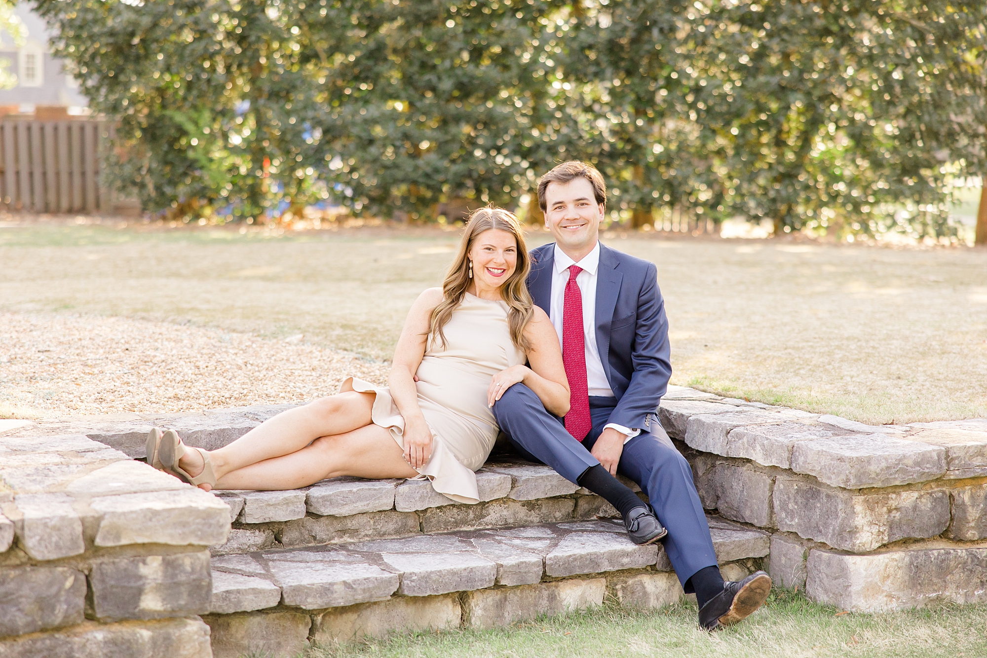 engagement portraits of couple sitting on stone stairs